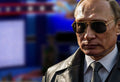 President Putin standing in front of US election debate stage wearing shades